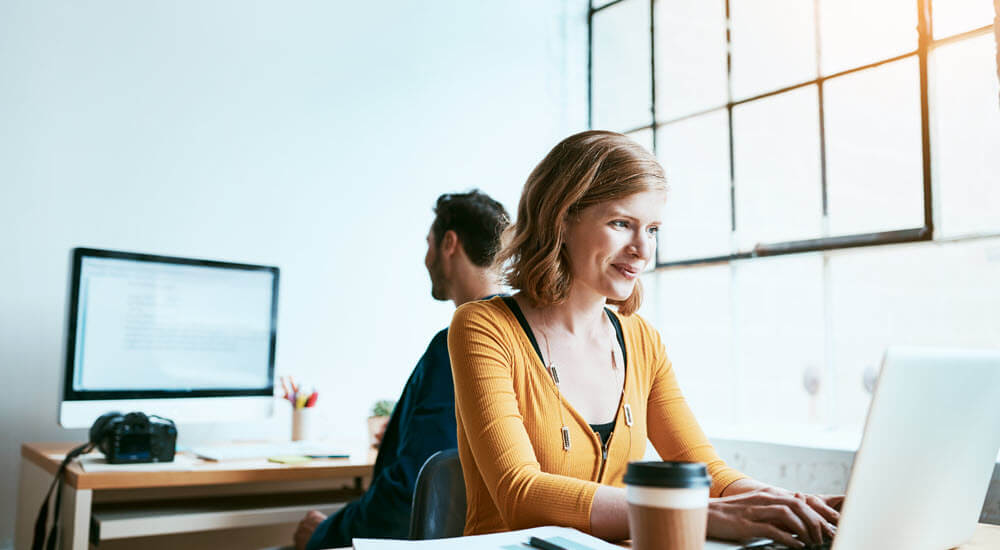 Young woman at work taking an online e-learning course